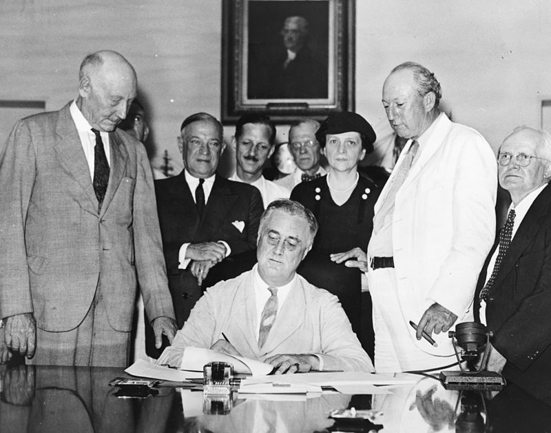 President FDR signs Social Security Act into law.